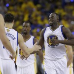 Golden State Warriors forward Draymond Green (23) is greeted by teammates during the second half of Game 1 of basketball's NBA Finals against the Cleveland Cavaliers in Oakland, Calif., Thursday, June 2, 2016. (AP Photo/Marcio Jose Sanchez)