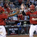 Arizona Diamondbacks' Michael Bourn (1) and Phil Gosselin, right, celebrate after both scored on a double by teammate Paul Goldschmidt against the Philadelphia Phillies during the seventh inning of a baseball game Wednesday, June 29, 2016, in Phoenix. (AP Photo/Ross D. Franklin)