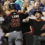 Arizona Diamondbacks' Jake Lamb, left, is congratulated by manager Chip Hale after Lamb scored on a single by Chris Herrmann off Colorado Rockies relief pitcher Boone Logan during the seventh inning of a baseball game Friday, June 24, 2016, in Denver. (AP Photo/David Zalubowski)