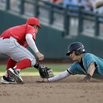 Arizona shortstop Louis Boyd, left, tags Coastal Carolina' s Billy Cooke out attempting to steal second base in the third inning in Game 1 of the NCAA Men's College World Series finals baseball game in Omaha, Neb., Monday, June 27, 2016. (AP Photo/Nati Harnik)