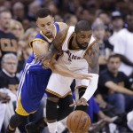 Golden State Warriors guard Stephen Curry (30) reaches against Cleveland Cavaliers guard Kyrie Irving (2) during the first half of Game 6 of basketball's NBA Finals in Cleveland, Thursday, June 16, 2016. (AP Photo/Tony Dejak)