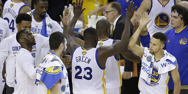 Golden State Warriors guard Stephen Curry (30), forward Draymond Green (23) and teammates celebrate...