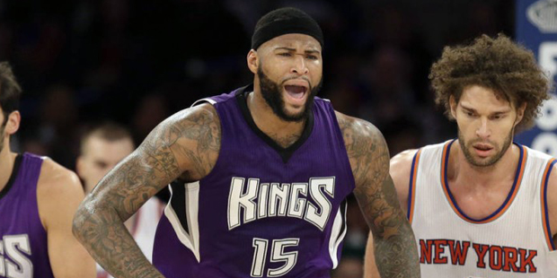 Sacramento Kings' DeMarcus Cousins, center, reacts after scoring during the second half of the NBA ...