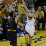 Golden State Warriors guard Klay Thompson (11) shoots against Cleveland Cavaliers forward Kevin Love (0) during the first half of Game 1 of basketball's NBA Finals in Oakland, Calif., Thursday, June 2, 2016. (AP Photo/Ben Margot)