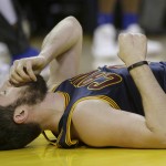 Cleveland Cavaliers forward Kevin Love remains on the floor after a play during the first half of Game 2 of basketball's NBA Finals between the Golden State Warriors and the Cavaliers in Oakland, Calif., Sunday, June 5, 2016. (AP Photo/Marcio Jose Sanchez)