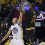 Golden State Warriors guard Stephen Curry (30) defends Cleveland Cavaliers forward LeBron James (23) during the first half of Game 7 of basketball's NBA Finals in Oakland, Calif., Sunday, June 19, 2016. (AP Photo/Marcio Jose Sanchez)