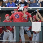 Arizona's Cody Deason (15) and Austin Rubick (25) have fun in the dugout before the fourth inning against Coastal Carolina in Game 1 of the NCAA Men's College World Series finals baseball game in Omaha, Neb., Monday, June 27, 2016. (AP Photo/Nati Harnik)