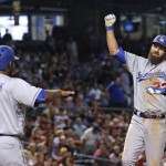 Los Angeles Dodgers' Scott Van Slyke, right, celebrates his three-run home run against the Arizona Diamondbacks with Howie Kendrick (47) and Adrian Gonzalez, left, during the sixth inning of a baseball game Wednesday, June 15, 2016, in Phoenix. (AP Photo/Ross D. Franklin)