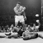 FILE - In this May 25, 1965, file photo, heavyweight champion Muhammad Ali, then known as Cassius Clay, stands over challenger Sonny Liston, shouting and gesturing shortly after dropping Liston with a short hard right to the jaw, in Lewiston, Maine. Ali, the magnificent heavyweight champion whose fast fists and irrepressible personality transcended sports and captivated the world, has died according to a statement released by his family Friday, June 3, 2016. He was 74.
 (AP Photo/John Rooney, File)