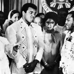FILE - In this Sept. 18, 1975, file photo, Philippines President Ferdinand Marcos, left, applauds as challenger Joe Frazier, right, makes some remarks about world champion Muhammad Ali, second from left, during their call on Marcos at the Malacanang Palace in Manila, Philippines.  Ali, the magnificent heavyweight champion whose fast fists and irrepressible personality transcended sports and captivated the world, has died according to a statement released by his family Friday, June 3, 2016. He was 74. (AP Photo/Jess Tan, File)