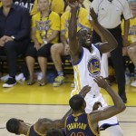 Golden State Warriors forward Draymond Green (23) shoots against Cleveland Cavaliers guard J.R. Smith, bottom left, and center Tristan Thompson (13) during the first half of Game 2 of basketball's NBA Finals in Oakland, Calif., Sunday, June 5, 2016. (AP Photo/Marcio Jose Sanchez)