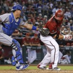 Los Angeles Dodgers' A.J. Ellis, left, tags out Arizona Diamondbacks' Welington Castillo, right, after the third strike was dropped by Ellis during the second inning of a baseball game Wednesday, June 15, 2016, in Phoenix. (AP Photo/Ross D. Franklin)