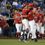 Arizona catcher Ryan Haug, front left, and relief pitcher Cameron Ming celebrate as teammates run out of the dugout following an NCAA College World Series baseball game against UC Santa Barbara, Wednesday, June 22, 2016, in Omaha, Neb. Arizona won 3-0. (AP Photo/Ted Kirk)