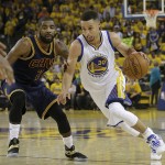 Golden State Warriors guard Stephen Curry (30) dribbles against Cleveland Cavaliers guard Kyrie Irving (2) during the first half of Game 1 of basketball's NBA Finals in Oakland, Calif., Thursday, June 2, 2016. (AP Photo/Marcio Jose Sanchez)