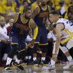 Cleveland Cavaliers guard Kyrie Irving (2) dribbles against Golden State Warriors guard Stephen Curry during the first half of Game 1 of basketball's NBA Finals in Oakland, Calif., Thursday, June 2, 2016. (AP Photo/Marcio Jose Sanchez)