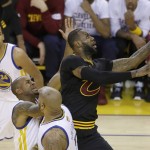 Cleveland Cavaliers forward LeBron James, right, shoots against the Golden State Warriors during the first half of Game 7 of basketball's NBA Finals in Oakland, Calif., Sunday, June 19, 2016. (AP Photo/Eric Risberg)