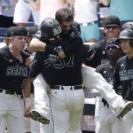 Coastal Carolina's G.K. Young (37) is hugged by Anthony Marks after hitting a two-run home run against Arizona in the sixth inning in Game 3 of the NCAA College World Series baseball finals in Omaha, Neb., Thursday, June 30, 2016. (AP Photo/Nati Harnik)