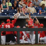 Arizona players spray water and dance in the dugout against Coastal Carolina in the fourth inning of Game 2 of the NCAA Men's College World Series finals baseball game in Omaha, Neb., Tuesday, June 28, 2016. (AP Photo/Ted Kirk)