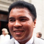 FILE - This is a 1995 file photo showing Muhammad Ali smiling during a visit to New York. Ali, the magnificent heavyweight champion whose fast fists and irrepressible personality transcended sports and captivated the world, has died according to a statement released by his family Friday, June 3, 2016. He was 74. (AP Photo/Mark Lennihan, FIle)