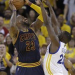 Cleveland Cavaliers forward LeBron James, left, shoots against Golden State Warriors forward Draymond Green during the first half of Game 2 of basketball's NBA Finals in Oakland, Calif., Sunday, June 5, 2016. (AP Photo/Marcio Jose Sanchez)
