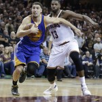 Golden State Warriors guard Klay Thompson (11) drives on Cleveland Cavaliers center Tristan Thompson (13) during the first half of Game 6 of basketball's NBA Finals in Cleveland, Thursday, June 16, 2016. (AP Photo/Tony Dejak)