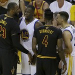 Cleveland Cavaliers forward LeBron James, left, and Golden State Warriors guard Stephen Curry, right, are separated by forward Draymond Green (23) and guard Iman Shumpert (4) during the first half of Game 7 of basketball's NBA Finals in Oakland, Calif., Sunday, June 19, 2016. (AP Photo/Marcio Jose Sanchez)