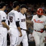 Philadelphia Phillies Freddy Galvis, right, heads to the dugout after being caught in a run down as Arizona Diamondbacks Jake Lamb, Randall Delgado (48) and Nick Ahmed (13) look on during the fourth inning of a baseball game, Tuesday, June 28, 2016, in Phoenix. (AP Photo/Matt York)