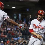 Philadelphia Phillies' Andres Blanco, right, shouts as he celebrates with Ryan Howard after scoring against the Arizona Diamondbacks during the eighth inning of a baseball game Wednesday, June 29, 2016, in Phoenix. (AP Photo/Ross D. Franklin)