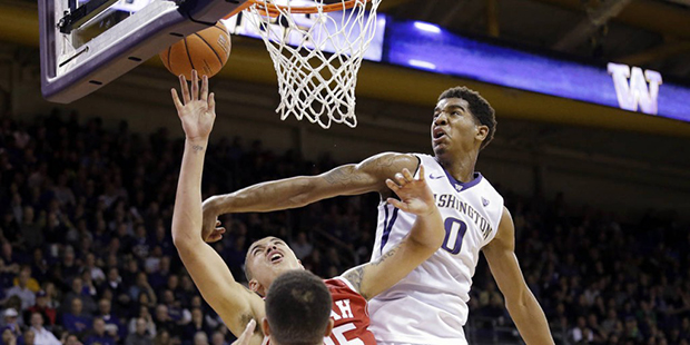 Washington's Marquese Chriss (0) blocks a shot by Utah's Kyle Kuzma in the first half of an NCAA co...