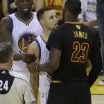 Golden State Warriors' Stephen Curry, center, is held by Draymond Green, left, as he talks with Cleveland Cavaliers forward LeBron James (23) during the first half of Game 7 of basketball's NBA Finals in Oakland, Calif., Sunday, June 19, 2016. (AP Photo/Marcio Jose Sanchez)