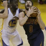 Cleveland Cavaliers forward Kevin Love (0) shoots against Golden State Warriors forward Draymond Green (23) during the first half of Game 2 of basketball's NBA Finals in Oakland, Calif., Sunday, June 5, 2016. (AP Photo/Ben Margot)