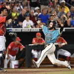 Coastal Carolina's Anthony Marks (29) scores on a Connor Owings single against Arizona in the eighth inning in Game 2 of the NCAA Men's College World Series finals baseball game in Omaha, Neb., Tuesday, June 28, 2016. (AP Photo/Ted Kirk)