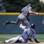 Arizona Diamondbacks second baseman Brandon Drury, top, jumps over Colorado Rockies' Charlie Blackmon after forcing him out at second base on the front end of a double play hit into by DJ LeMahieu in the first inning of a baseball game Sunday, June 26, 2016, in Denver. (AP Photo/David Zalubowski)