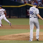 Los Angeles Dodgers' Mike Bolsinger walks back to the mound after giving up a home run to Arizona Diamondbacks' Jake Lamb, left, during the third inning of a baseball game Monday, June 13, 2016, in Phoenix. (AP Photo/Ross D. Franklin)