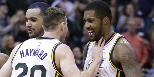 Utah Jazz's Derrick Favors, right, celebrates with Gordon Hayward after scoring against the Indiana...
