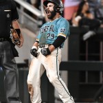 Coastal Carolina's Anthony Marks reacts to scoring on a Connor Owings single against Arizona in the eighth inning in Game 2 of the NCAA Men's College World Series finals baseball game in Omaha, Neb., Tuesday, June 28, 2016. (AP Photo/Ted Kirk)
