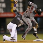 Colorado Rockies shortstop Trevor Story, left, tags out Arizona Diamondbacks' Phil Gosselin as he slides into second base trying to stretch a single into a double in the seventh inning of a baseball game Thursday, June 23, 2016, in Denver. The Diamondbacks won 7-6. (AP Photo/David Zalubowski)