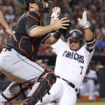 Arizona Diamondbacks' Welington Castillo (7) slides safely into home plate to score a run as Miami Marlins' Jeff Mathis, left, waits for a late throw during the fifth inning of a baseball game Friday, June 10, 2016, in Phoenix. (AP Photo/Ross D. Franklin)