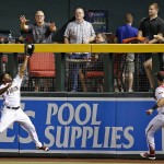 Arizona Diamondbacks' Michael Bourn, left, makes a leaping catch at the wall on a fly ball hit by Tampa Bay Rays' Evan Longoria as Diamondbacks' David Peralta , right, watches during the third inning of a baseball game Monday, June 6, 2016, in Phoenix. (AP Photo/Ross D. Franklin)