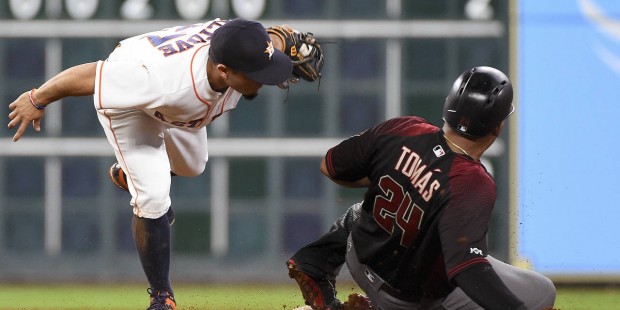 Houston Astros second baseman Jose Altuve, left, tags out Arizona Diamondbacks' Yasmany Tomas on a ...