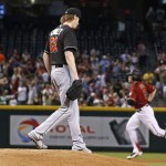 Miami Marlins pitcher Adam Conley (61) pauses on the mound as Arizona Diamondbacks' Peter O'Brien, right, rounds the bases after hitting a three-run home run during the first inning of a baseball game Sunday, June 12, 2016, in Phoenix. (AP Photo/Ross D. Franklin)