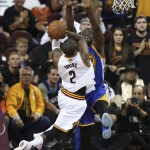 Cleveland Cavaliers guard Kyrie Irving (2) drives on Golden State Warriors forward Draymond Green (23) during the second half of Game 6 of basketball's NBA Finals in Cleveland, Thursday, June 16, 2016. (AP Photo/Ron Schwane)