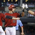 Arizona Diamondbacks' Jake Lamb (22) celebrates his three-run home run against the Philadelphia Phillies with Phil Gosselin (15) and Paul Goldschmidt, right, during the first inning of a baseball game Wednesday, June 29, 2016, in Phoenix. (AP Photo/Ross D. Franklin)