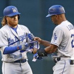 Los Angeles Dodgers' Justin Turner, left, gets a fist-bump from first base coach George Lombard after Turner's run-scoring double against the Arizona Diamondbacks during the first inning of a baseball game Monday, June 13, 2016, in Phoenix. (AP Photo/Ross D. Franklin)