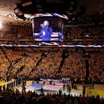 Fans at Oracle Arena watch as musician Aloe Blacc performs the national anthem before Game 7 of basketball's NBA Finals between the Golden State Warriors and the Cleveland Cavaliers in Oakland, Calif., Sunday, June 19, 2016. (AP Photo/Eric Risberg)