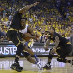 Golden State Warriors forward Harrison Barnes (40) drives between Cleveland Cavaliers center Tristan Thompson, left, and guard J.R. Smith during the first half of Game 7 of basketball's NBA Finals in Oakland, Calif., Sunday, June 19, 2016. (AP Photo/Marcio Jose Sanchez)