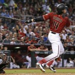 Arizona Diamondbacks' Peter O'Brien (14) watches the flight of his three-run home run as Miami Marlins' J.T. Realmuto, left, looks on during the first inning of a baseball game Sunday, June 12, 2016, in Phoenix. (AP Photo/Ross D. Franklin)