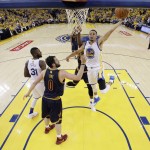 Golden State Warriors' Stephen Curry (30) drives to the basket past Cleveland Cavaliers' Kevin Love (0) during the second half in Game 1 of basketball's NBA Finals Thursday, June 2, 2016, in Oakland, Calif. (AP Photo/Marcio Jose Sanchez, Pool)