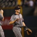Arizona Diamondbacks shortstop Nick Ahmed, center, smiles as he is congratulated by first baseman Paul Goldschmidt, left, and catcher Welington Castillo after the Diamondbacks retired the Colorado Rockies in the ninth inning of a baseball game Thursday, June 23, 2016, in Denver. The Diamondbacks won 7-6 on an RBI-single hit by Ahmed. (AP Photo/David Zalubowski)
