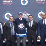 Patrik Laine, center, second overall pick, stands with members of the Winnipeg Jets management team at the NHL draft in Buffalo, N.Y., Friday June 24, 2016. (Nathan Denette/The Canadian Press via AP) MANDATORY CREDIT